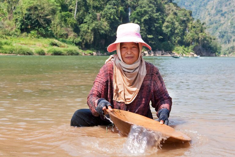 Woman-washing-gold-in-river-nam-ou-in-Laos