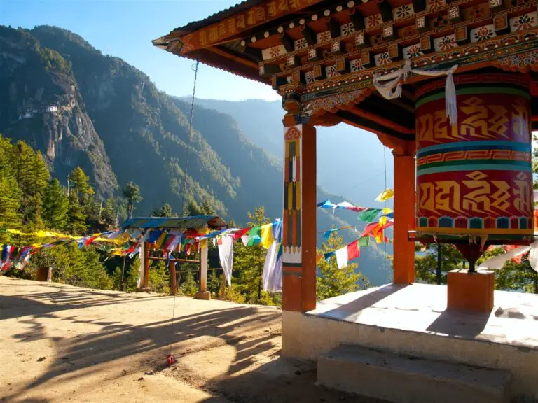 9.1 Wouter Tolenaars Dreamstime.com 19567871 View of the Taktshang monastery in Paro Bhutan with prayer flags and a prayer wheel in the front