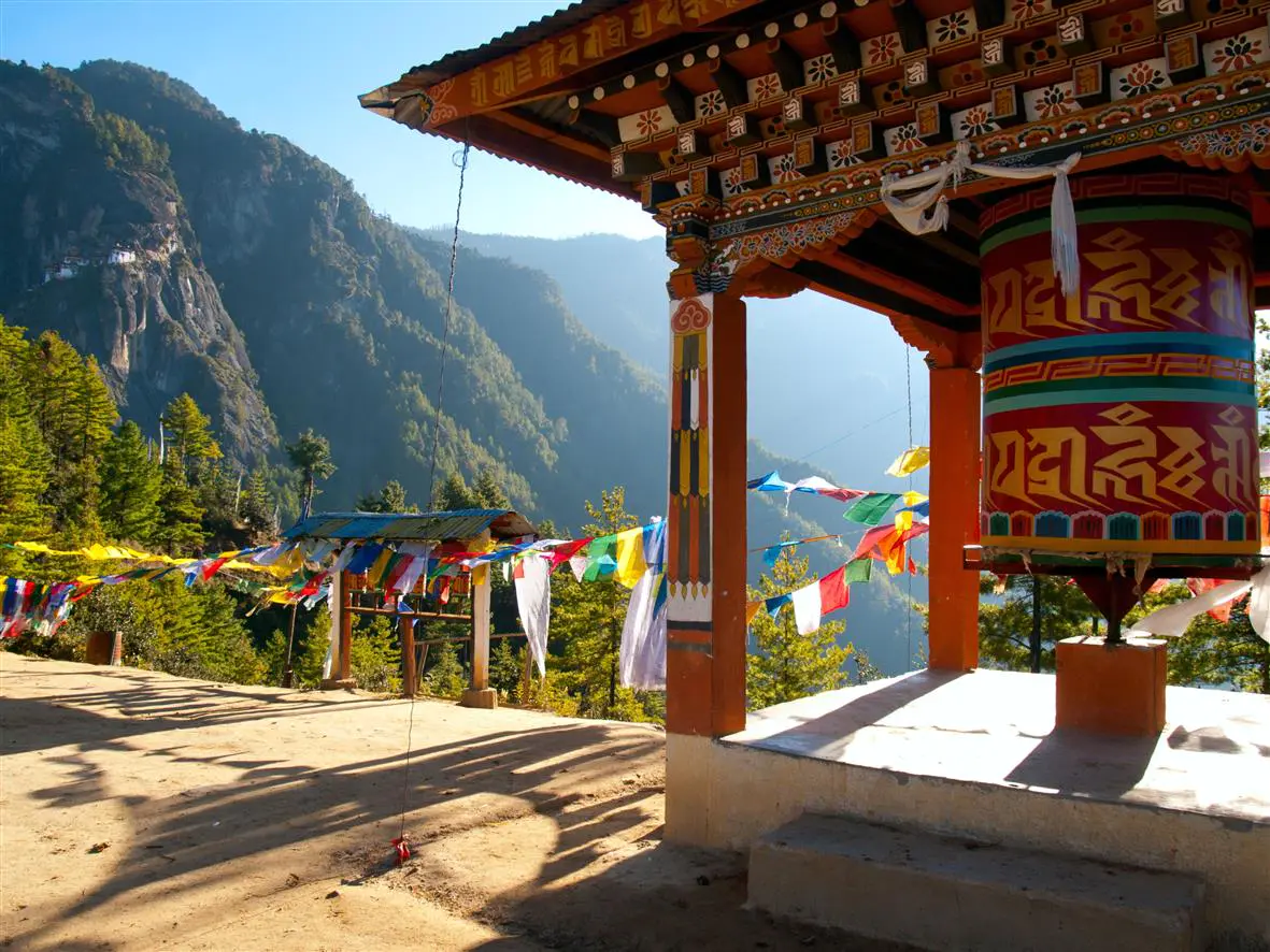 9.1 Wouter Tolenaars Dreamstime.com 19567871 View of the Taktshang monastery in Paro Bhutan with prayer flags and a prayer wheel in the front